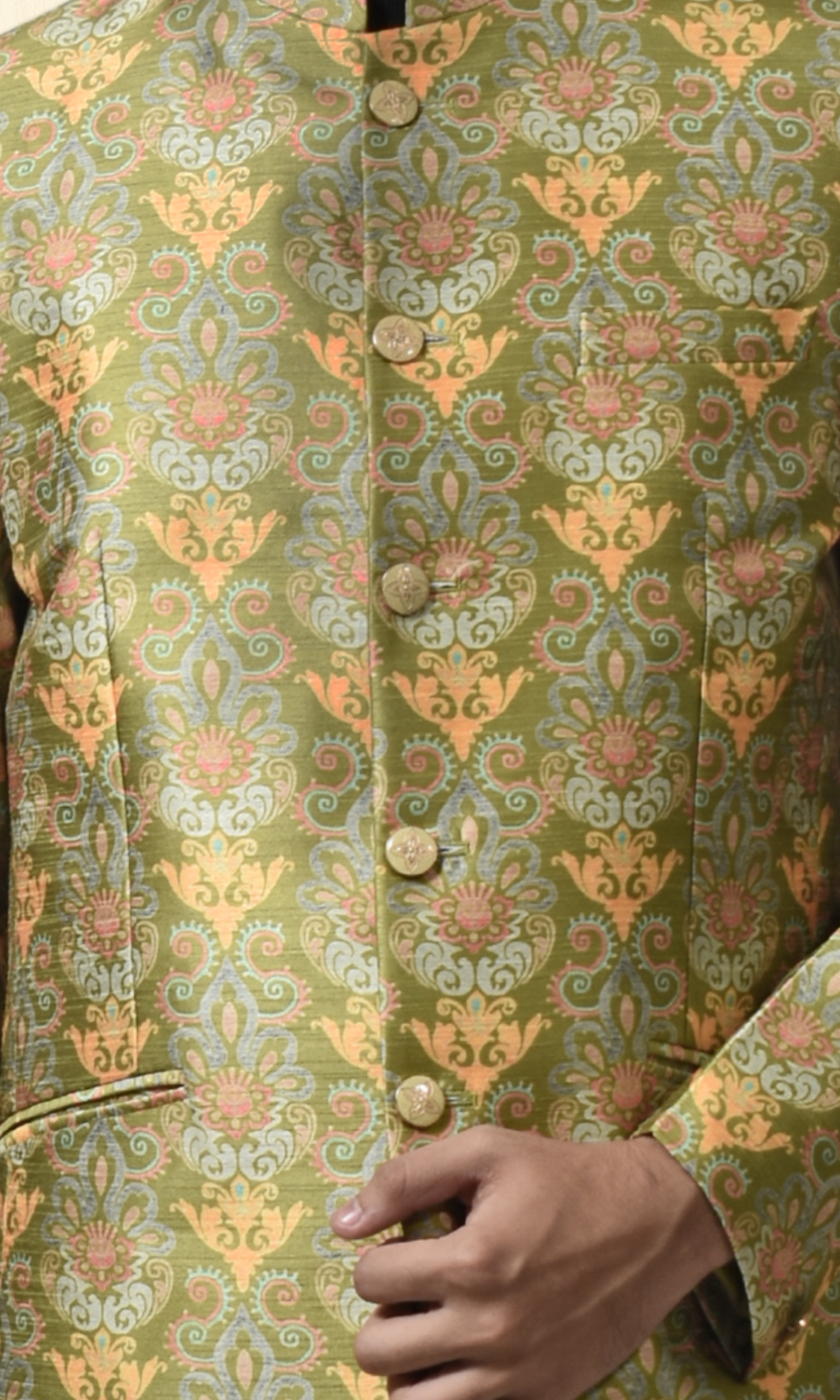 Regal green bandhgala with intricate floral and paisley motifs