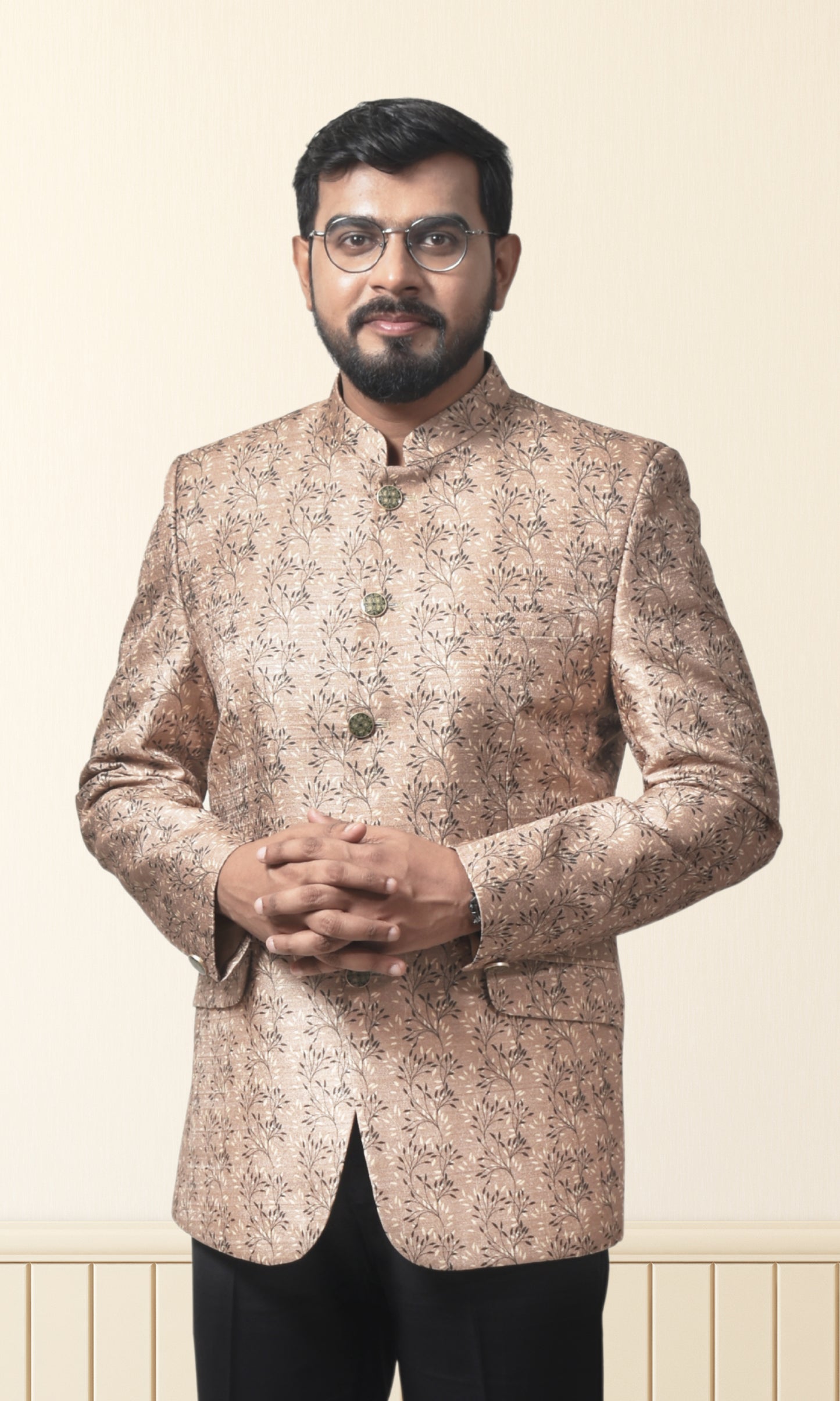 Regal beige bandhgala with intricate floral motifs and gold accents